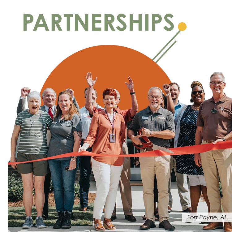 PARTNERSHIPS-annual-report-NW A diverse group of people enthusiastically cut a red ribbon in front of a building, smiling and clapping. The word “PARTNERSHIPS” appears at the top with a bold dot design, and the location “Fort Payne, AL” is noted at the bottom right.